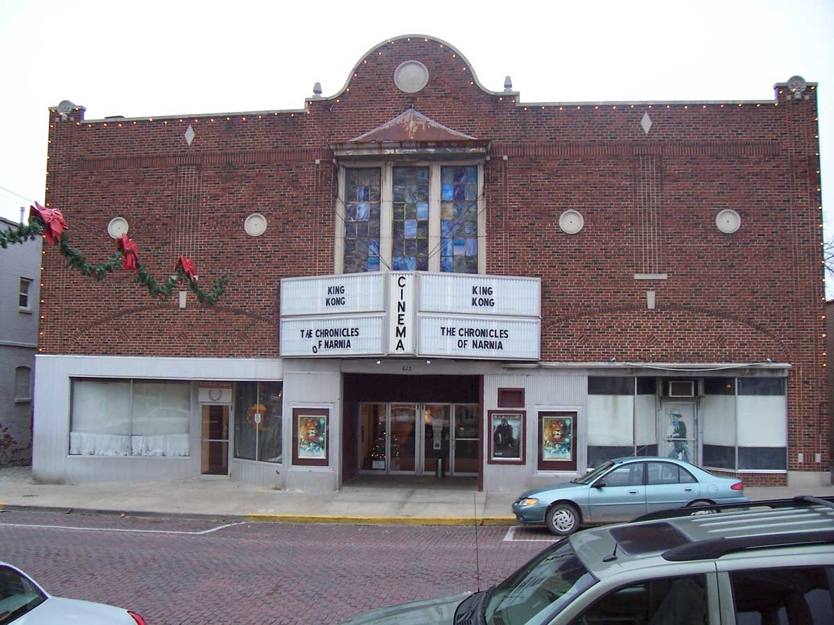 brick theatre front with Christmas garland hanging over brick street