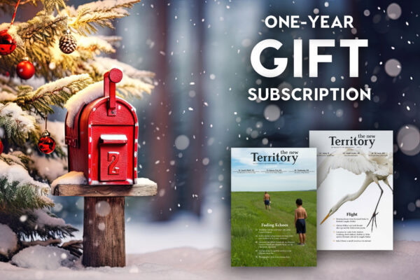 A snowy holiday scene in the background of a graphic that says "one-year gift subscription" with two copies of the handsome New Territory magazine pictured below the text.