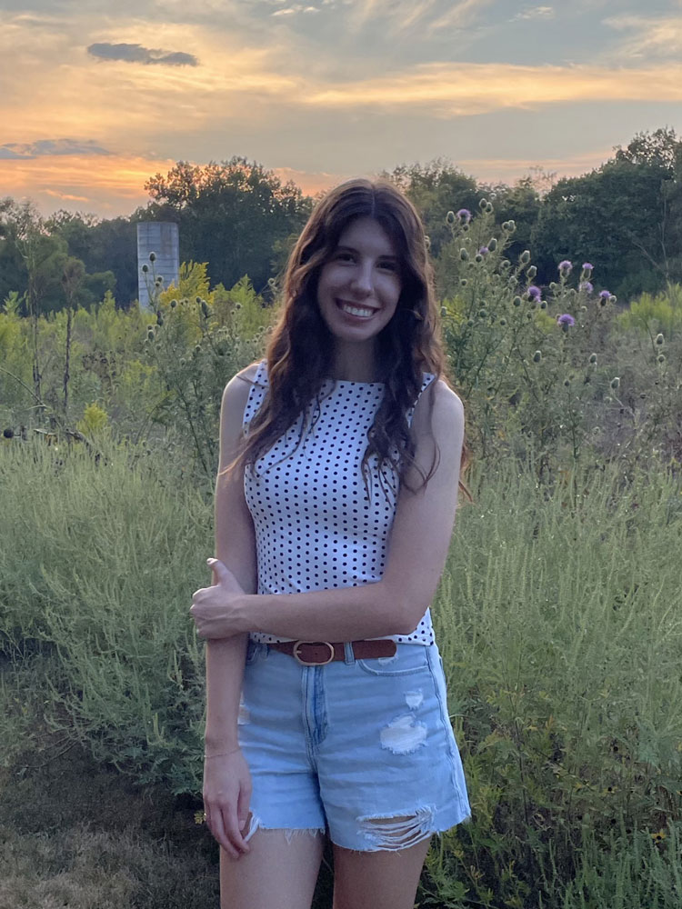 portrait of a woman in front of a prairie sunset