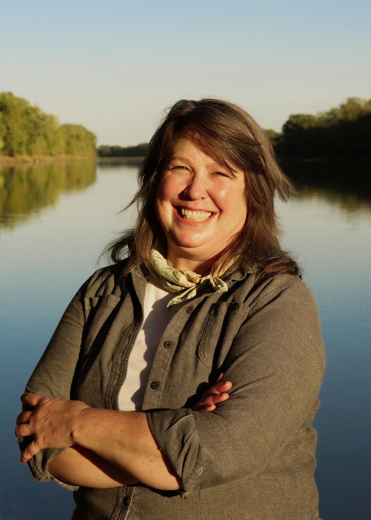 woman smiling with the Kansas River in the background