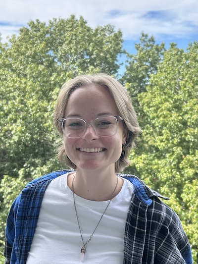 portrait of a woman in front of a prairie sunset