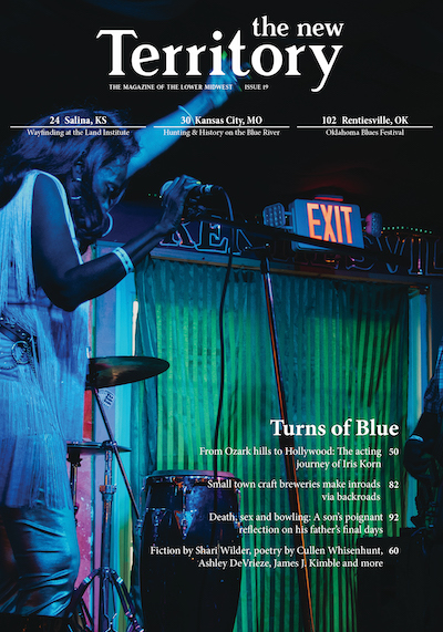 magazine cover with yellow flowers and a warbler bird on the cover